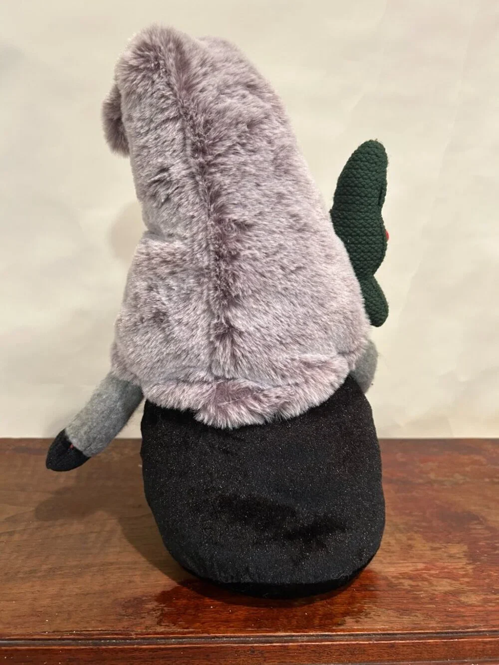 Christmas Holiday Gnome with gray cap and wispy white beard, holding tree